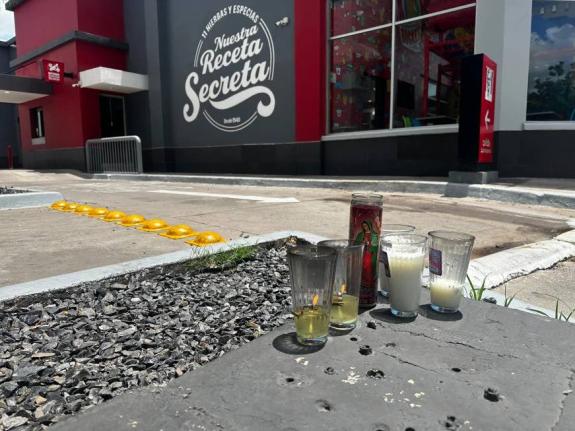 Candles sit near the spot where César Gastélum, a social media influencer, was killed the previous night in Culiacán, Mexico, Wednesday, August 5, 2026.