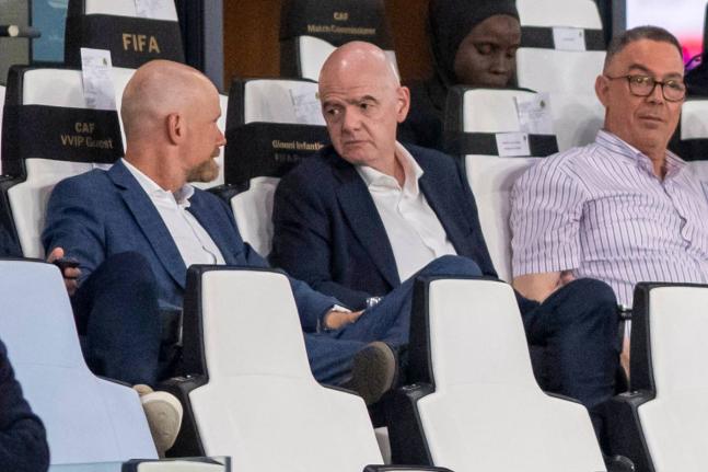 FIFA president Gianni Infantino (centre)  speaks to secretary general Mattias Grafstrom (left), while sitting beside president of Moroccan Royal Football Federation Fouzi Lekjaa as they attend a Women’s AFCON 2026 soccer match between Malawi and Zambia, 
