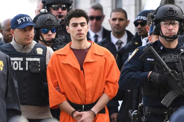 Luigi Mangione is escorted by police, December 19, 2024, in New York. 