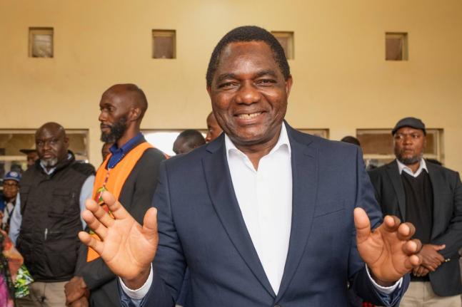 Zambia’s President Hakainde Hichilema shares a light moment with journalists after casting his vote at a polling station in Lusaka, Zambia, Thursday.