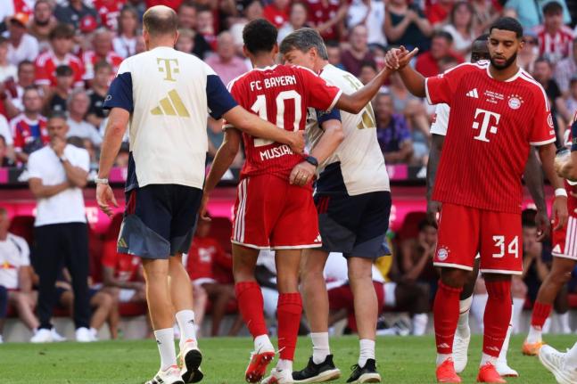Munich's Jamal Musiala (center) leaves the pitch due to an injury during a pre-season soccer match between FC Bayern Munich and RB Leipzig in Munich, Germany, on Saturday. - AP photo