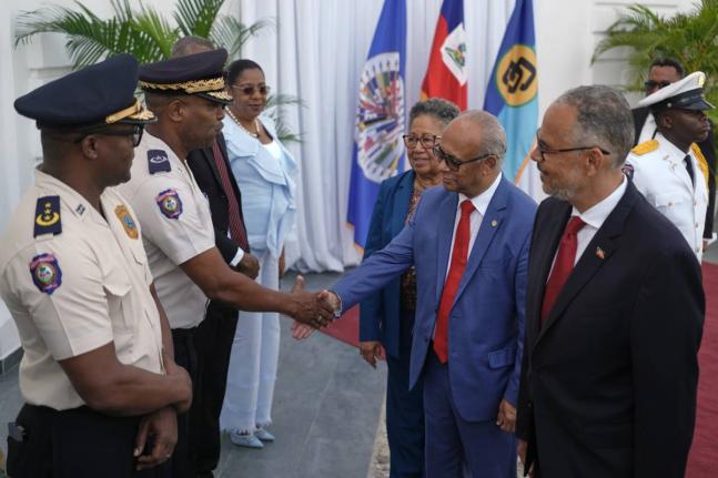 Haiti’s Prime Minister Alix Didier Fils-Aime (far right), Secretary-General of the Organization of American States (OAS), Albert Ramdin (second right), and CARICOM Secretary-General Carla Barnett greet senior police officials at the National Palace in Po