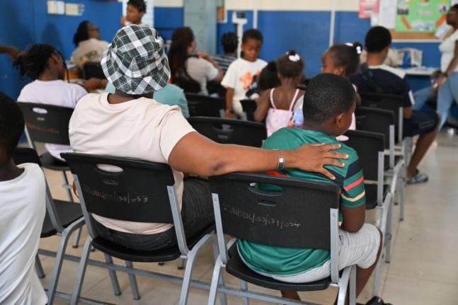 Parents and students wait at the Morant Bay Health Centre to access medical examinations and other services during the St Thomas Health Department's Back-to-School and Vaccination Drive on Saturday.