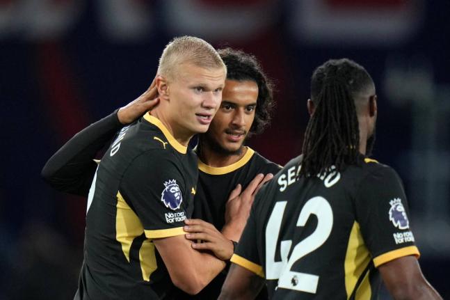 Manchester City’s Erling Haaland (left) celebrates with Avyoub Bouaddi and Antoine Semenyo (right, after sco)ing his side’s fourth goal during the English Premier League  match between Crystal Palace and Manchester City in London yesterday.