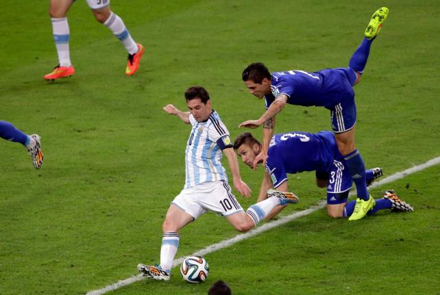 Argentina’s Lionel Messi scores his team’s second goal during the group F World Cup football match against Bosnia in Rio de Janeiro, Brazil, June 15, 2014. 