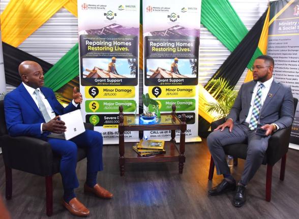 Labour and Social Security Minister, Pearnel Charles Jr. (left), making a point during a recent interview with Jamaica Information Service (JIS) Chief Executive Officer (CEO), Giovanni Dennis, at the Ministry’s North Street offices in St Andrew.