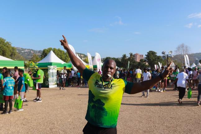 Stokely Rose, founder of TrainFit Club and race patron for the 5K Urban Forest Run 2026, celebrates after completing the race last August.