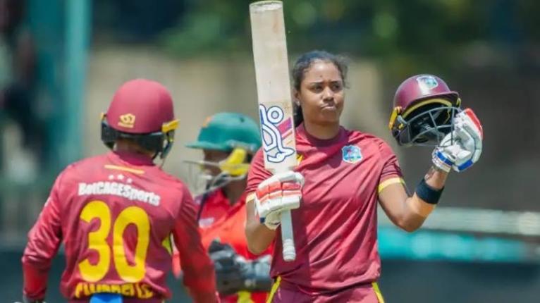 
West Indies women’s batter and captain, Hayley Matthews (right), celebrates scoring a century in the first One-Day International against Zimabwe in that country on Thursday.