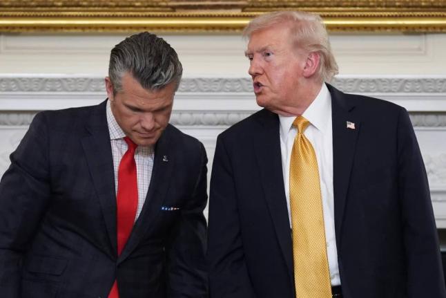 President Donald Trump talks with Defense Secretary Pete Hegseth after a roundtable on criminal cartels in the State Dining Room of the White House, October 23, 2025, in Washington. 