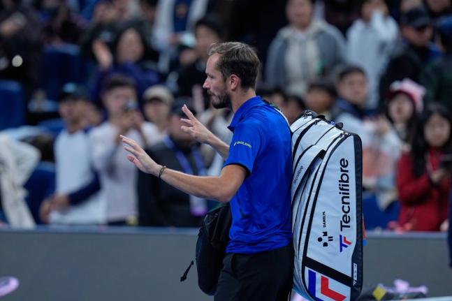 Daniil Medvedev, of Russia, leaves the court after being disqualified during a semi-final match against Novak Djokovic, of Serbia at the China Open tennis tournament in Beijing, yesterday.