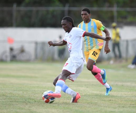 Rashaun Small (left) of Portmore United controls the ball ahead of  Ky-Mani Campbell  of Waterhouse  during the Jamaica Premier League match at the Ferdi Neita Park in St Catherine on Thursday. 
