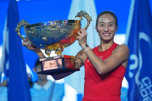 Zheng Qinwen, of China, poses with the trophy after winning the women’s singles final match against Mirra Andreeva of Russia at the China Open tennis tournament in Beijing, Sunday, October 11, 2026. 