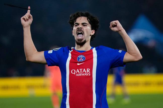 Paris Saint-Germain’s Vitinha celebrates after scoring his side’s third goal during the Champions League opening-phase football match against FC Barcelona in Paris, yesterday.