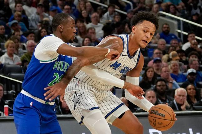 
Orlando Magic forward Paolo Banchero (right) tries to get past Minnesota Timberwolves forward Jonathan Kuminga during the first half of an NBA basketball game on Friday.
