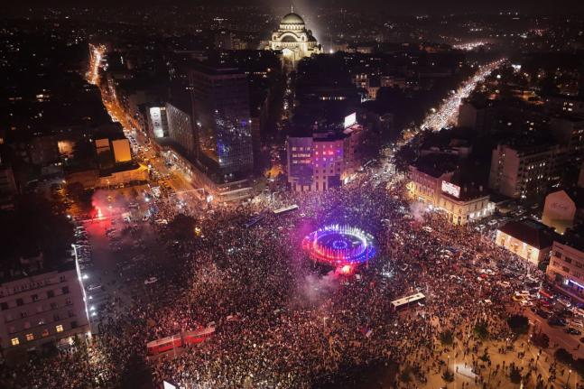People celebrate after Aleksandar Vučić, leader of the right-wing Serbian Progressive Party conceded defeat in the parliamentary election in Belgrade, Serbia, Sunay.