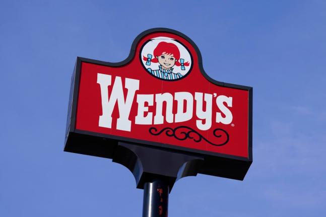 A sign stands over a Wendy’s restaurant, Feb. 25, 2021, in Des Moines, Iowa. 