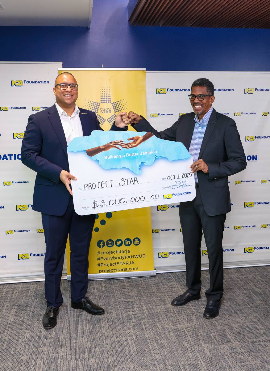 Perrin Gayle (left), CEO of NCB Foundation, hands over a symbolic cheque for J$3 million to Ian Neita, chair of Project STAR’s Monitoring and Reporting Committee, signifying NCB Foundation’s continued support to help expand Project STAR’s community t