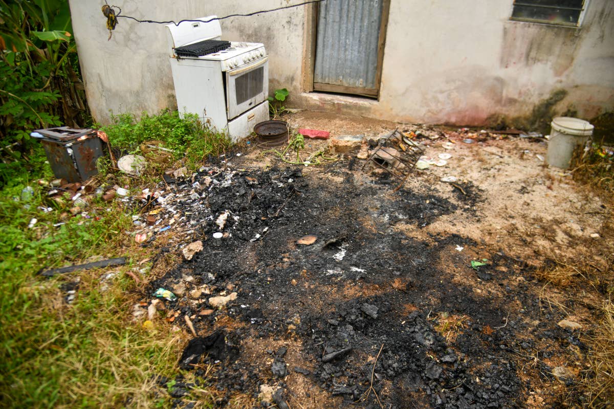 The area behind the home, where 13-year-old Shantina Sergeant’s burnt remains were found in the district of Riverside Drive in Bailleston, Clarendon, on Tuesday.