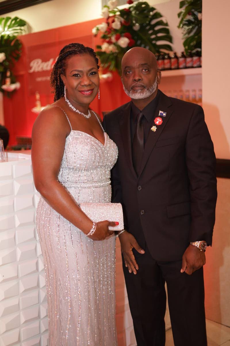 Lewis Smith (right), president of Crime Stop Turks & Caicos, is accompanied by Sonnie Hawkins, a registered nurse at Jackson Memorial Hospital, who wore a shimmering silver Camille La Vie gown from Florida.