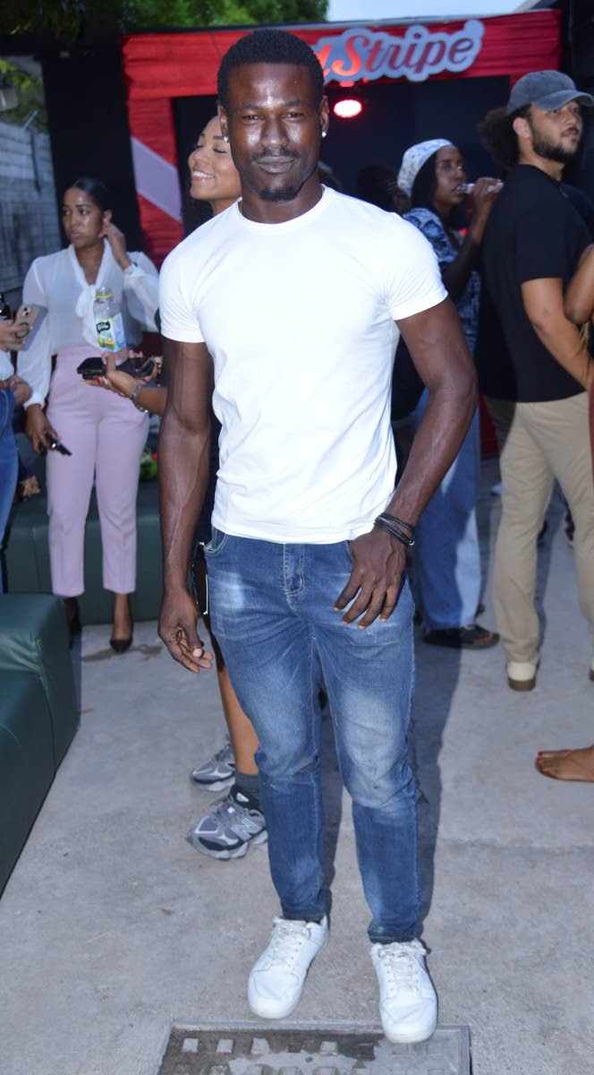 Easy does it for Mr World Jamaica 2024 Tarique Barrett, who paired a pristine white T-shirt with dark-wash jeans and low-tops. 