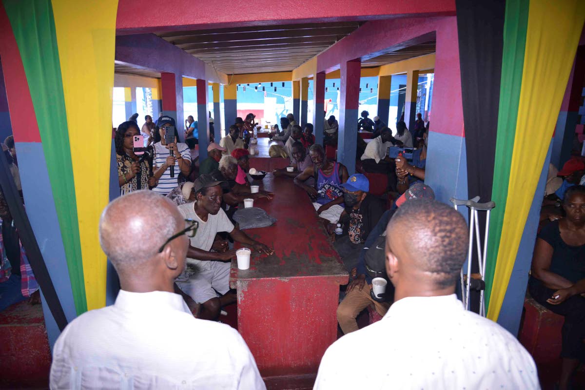 Desmond McKenzie (left), minister of local government and community development, and Mayor of Kingston Andrew Swaby (right) addressing members of the homeless community at the Marie Atkins Night Shelter along Hanover Street in Kingston on October 15. 