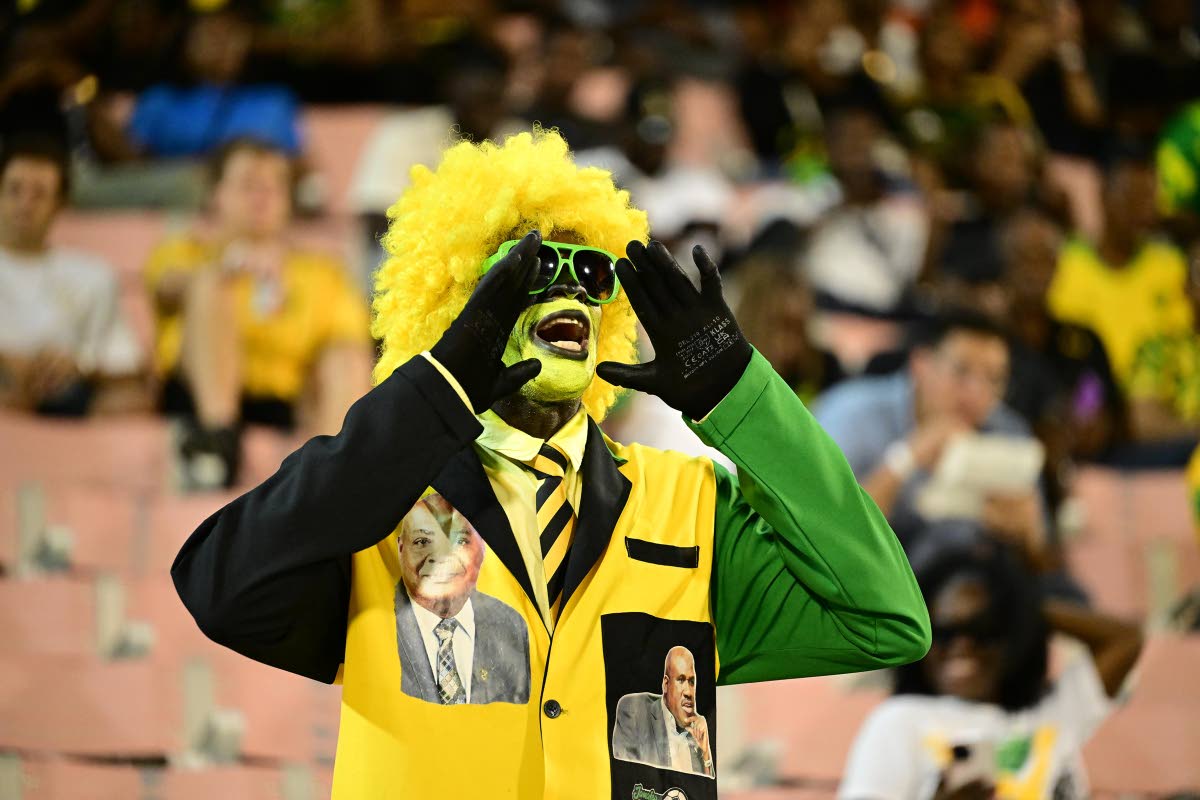 Reggae Boyz Mascot Wally Walters calls out to the players on the field. 