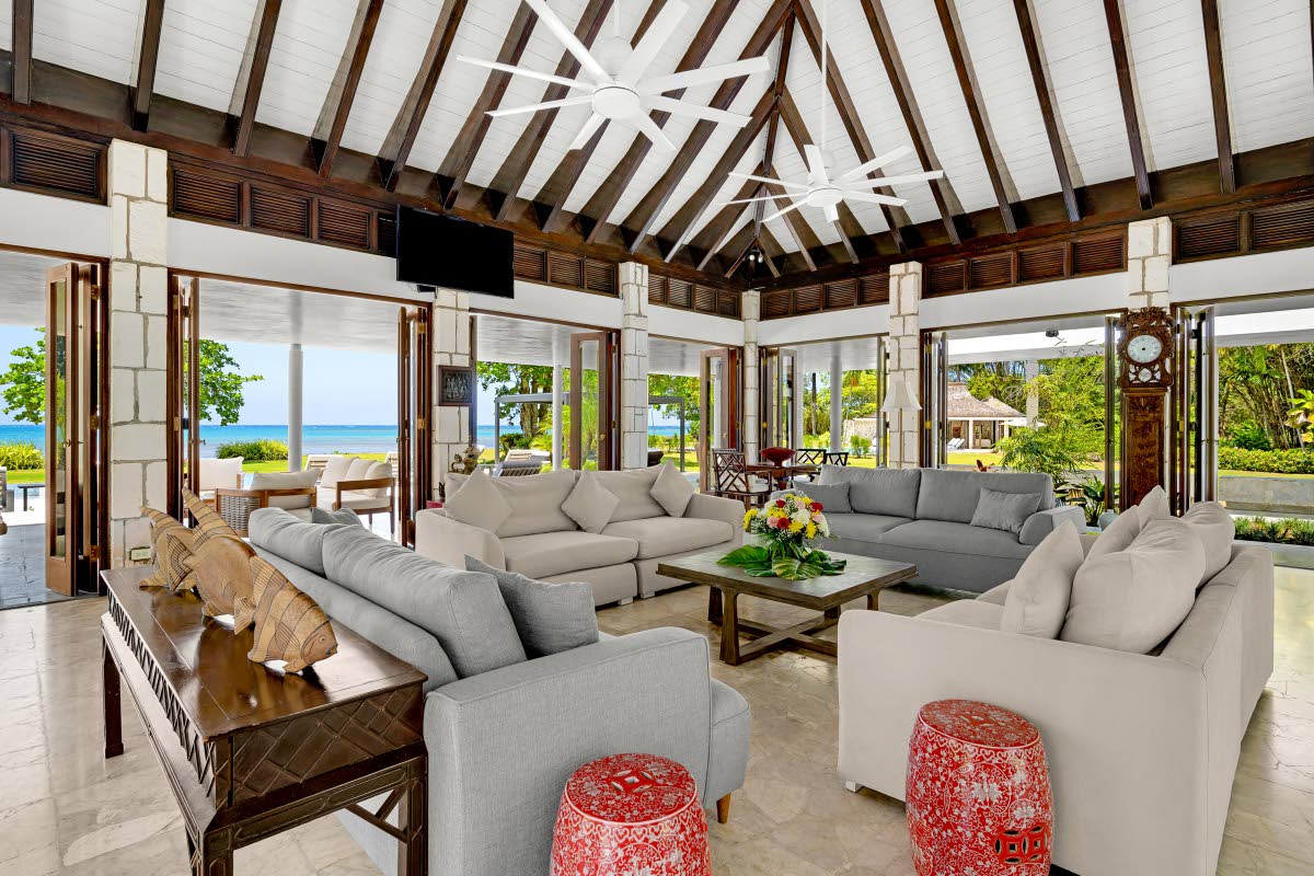 The incredible living room with its 56 glass doors looking out to sea.