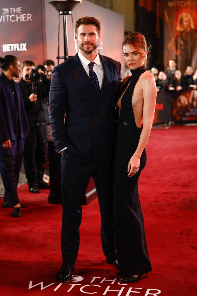 Liam Hemsworth, making his debut as the replacement for Henry Cavill in the role of Geralt of Rivia in ‘The Witcher’, poses on the red carpet with his fiancée, Gabriella Brooks.