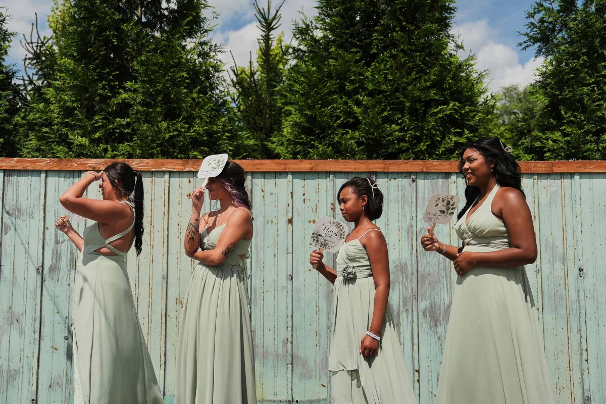 AP PHOTOS
TOP LEFT: Bridesmaids use fans for shade and to keep cool during bridal pictures before a wedding on August 23, 2025 in Newtown, Ohio.