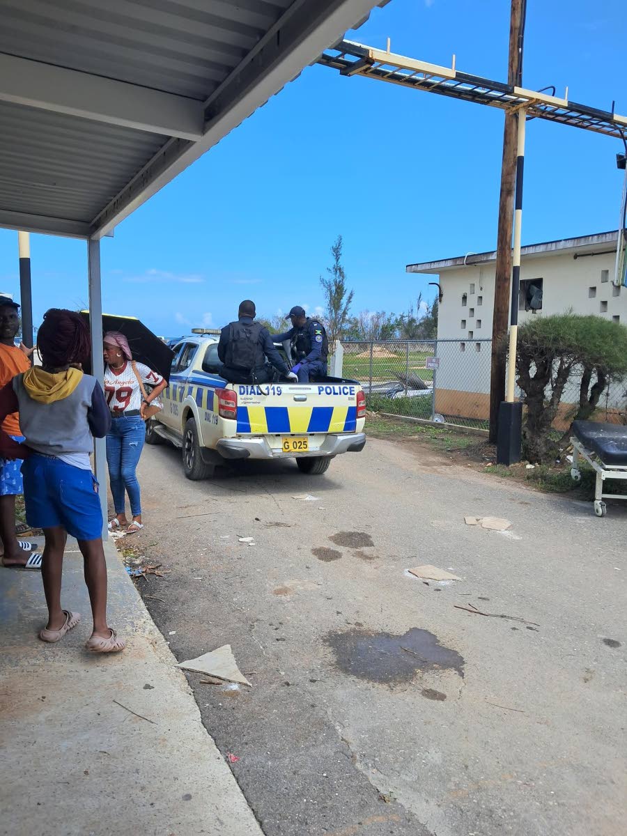Police officers transporting Gayan Dunbar's body to the morgue after leaving the Falmouth Hospital in Trelawny.