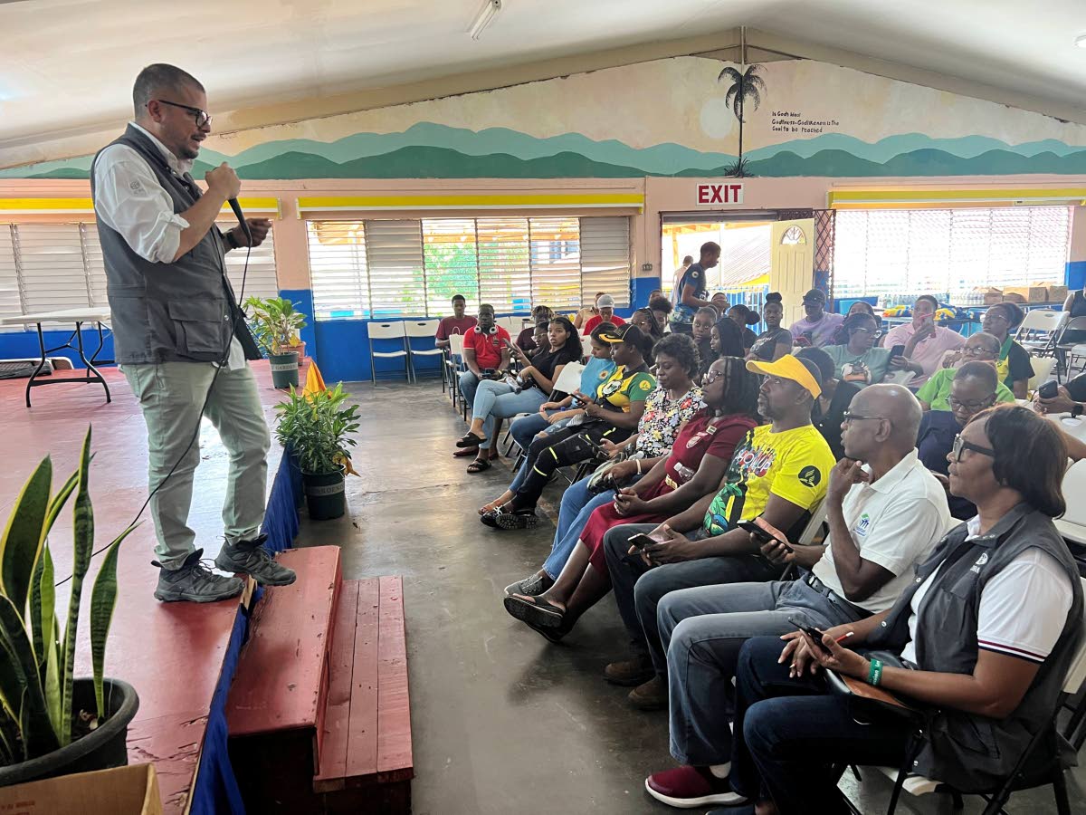 An ADRA International representative addresses volunteers at the Victor Dixon High School in Mandeville, Manchester, on Tuesday. 