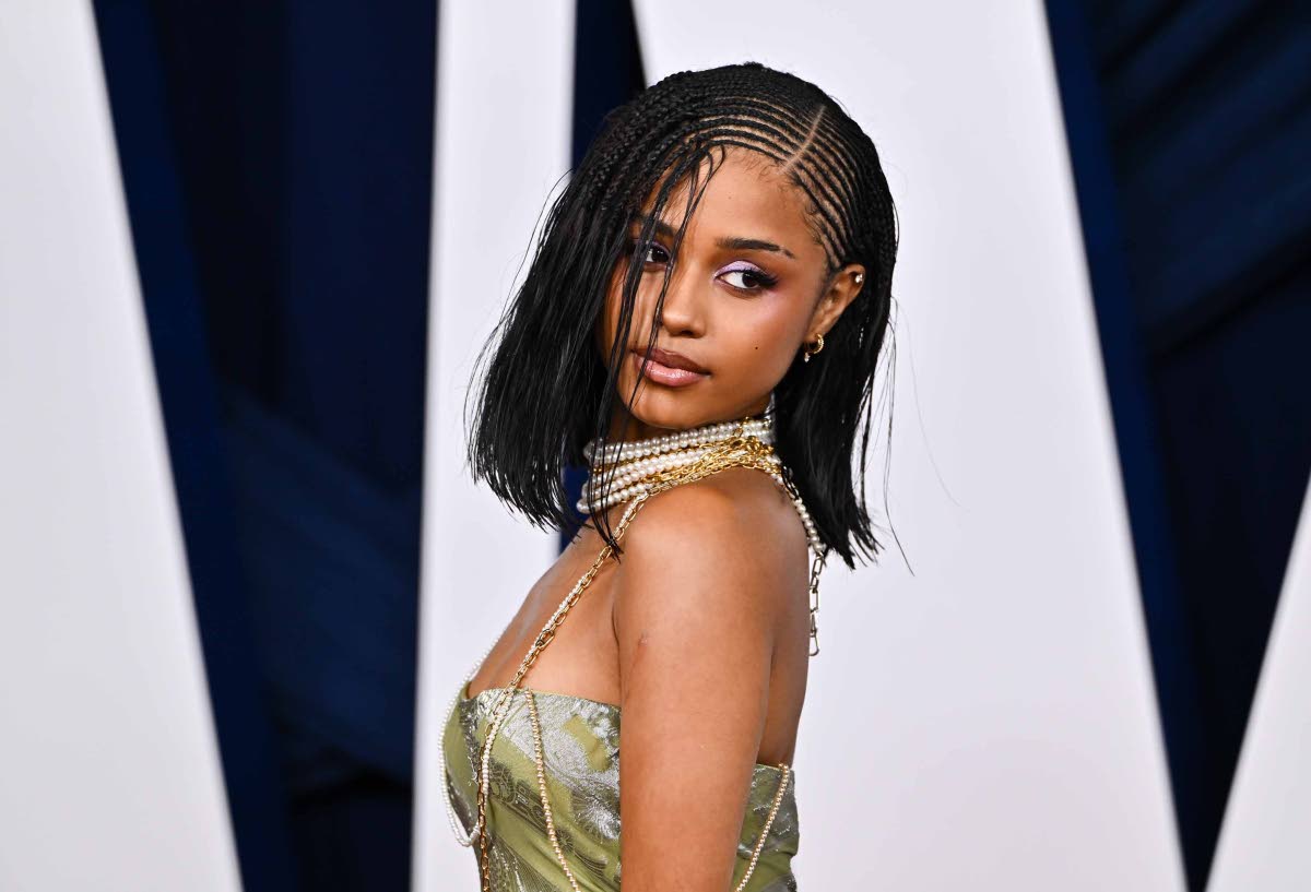 Honouree Tyla pairs a seafoam green Dior dress with pearl necklaces.