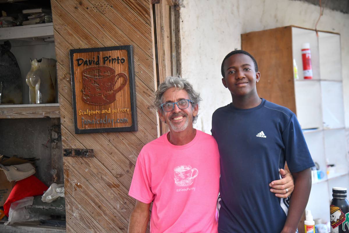 Lending a helping hand to his dad, Oscar poses beside his father, David Pinto.