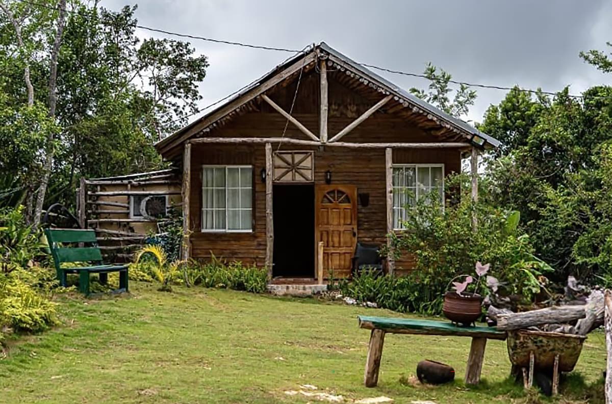 left: The rustic timber cottage in St Elizabeth, photographed in better days. 