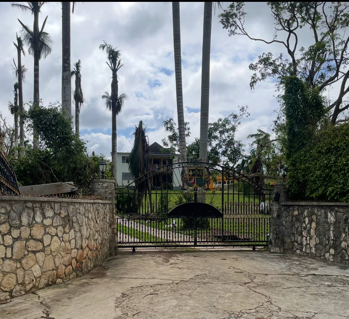 The gate to Jimmy Cliff’s home in Somerton, St James, with his house in the background.