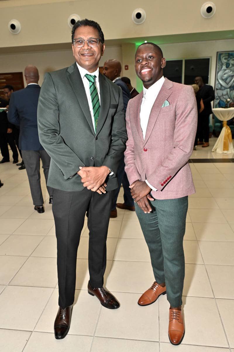 Seprod CEO Richard Pandohie (left) shares a moment with President’s Award honouree and World 100m Champion Oblique Seville.