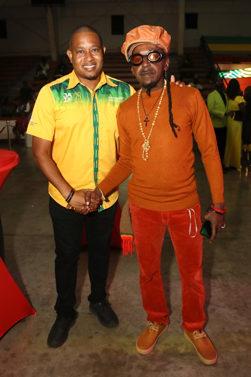 Below: Floyd Green (left), minister of agriculture, fisheries and mining, greets reggae artiste Abijah following his performance.