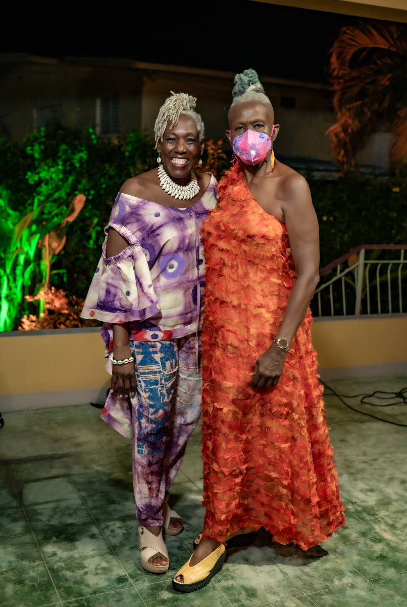 Toasting the woman of the hour, Carolyn Cooper (right), is her sister Donnette, who delivered a heartwarming speech.