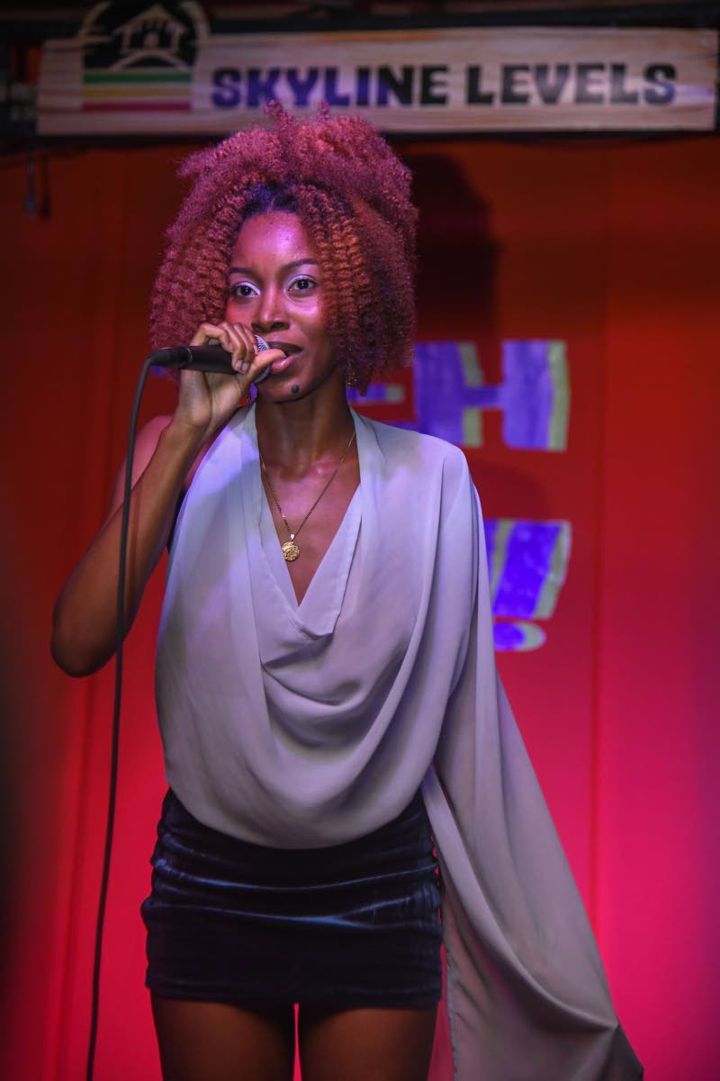 Artiste and songwriter Akina Eman steps out in a dramatic flounce top and velvet skirt.