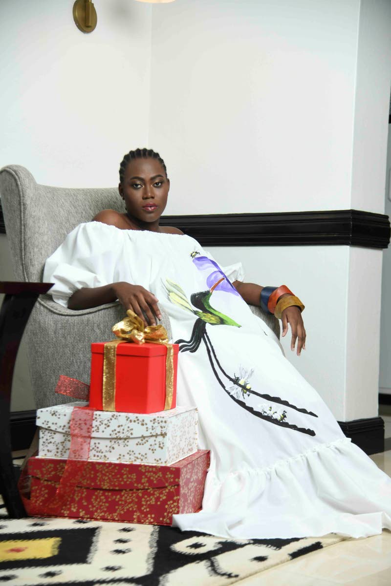 ‘Tis the season to consider a peasant-cut dress by designer Angella Wilkinson that features an acrylic-painted hummingbird by visual artist Tobean Walters as a focal point. 