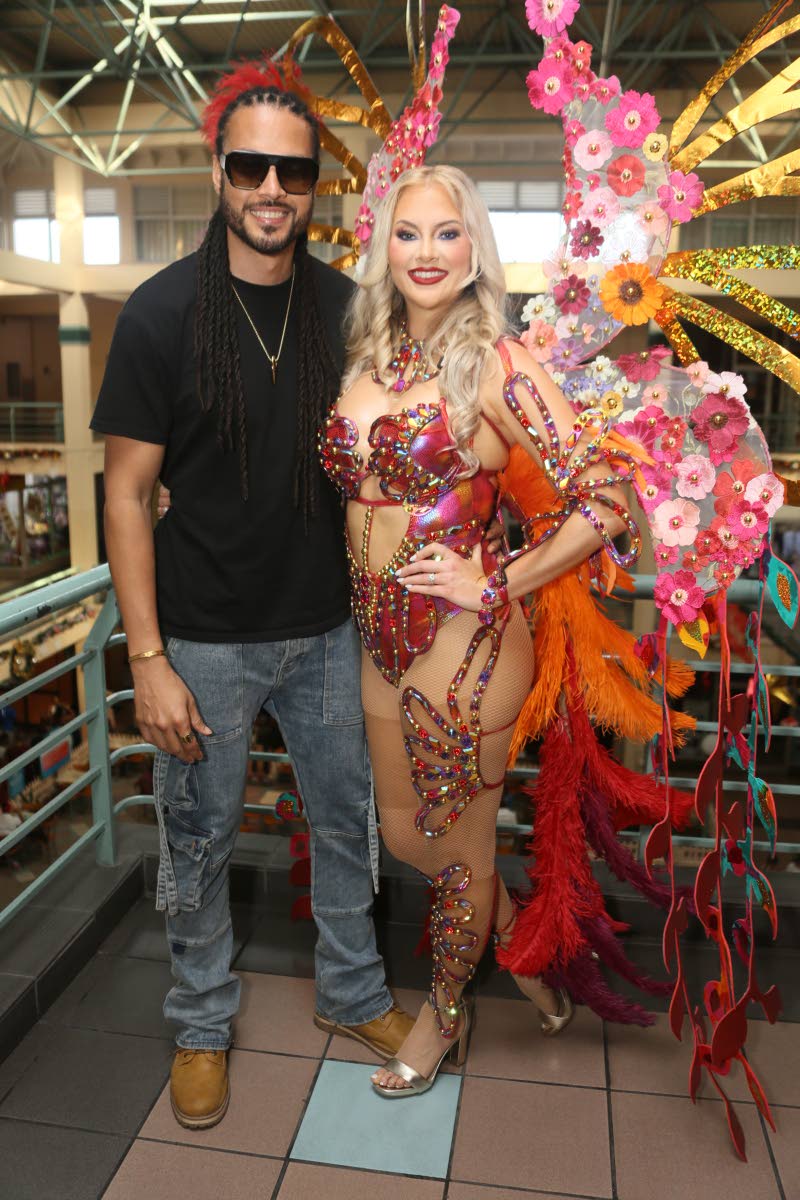 Reggae artiste Simon ‘Skygrass’ Bowen proudly holds his fiancée, Nicole Arbour, close.