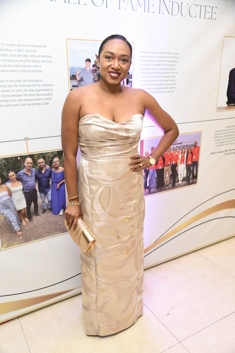 Luwanna Williams, president and CEO of PROVEN Wealth, commands attention in a radiant gold, floor-length dress.
