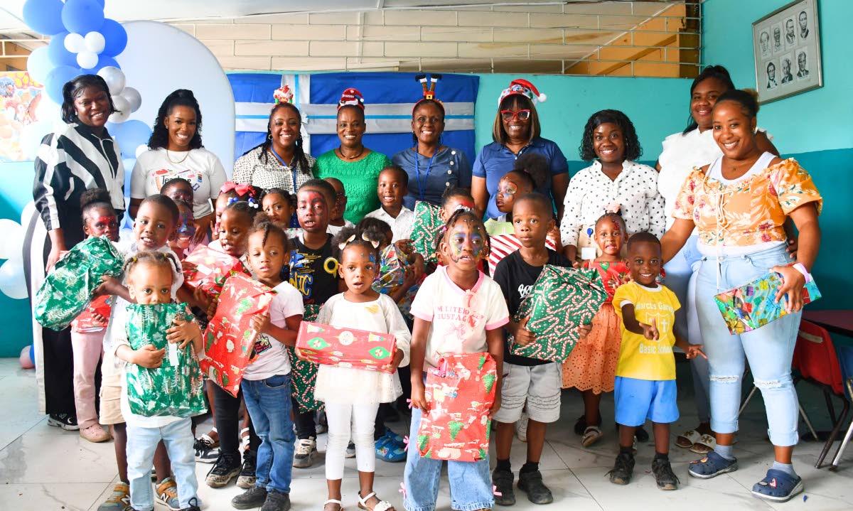 Students and staff of the Marcus Garvey Basic School join the Shipping Association of Jamaica team for a photo at the association’s annual Christmas treat.