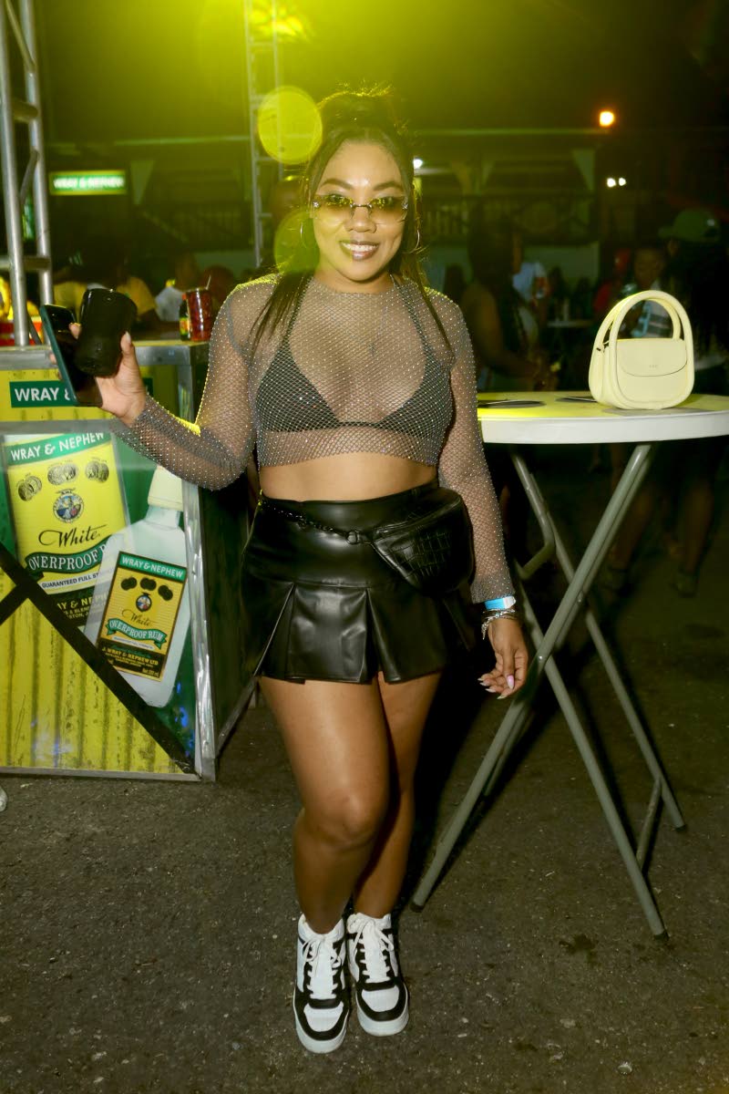 La Nea Lowe embraces early-2000s style in a long-sleeved mesh crop top, layered over a black bra.