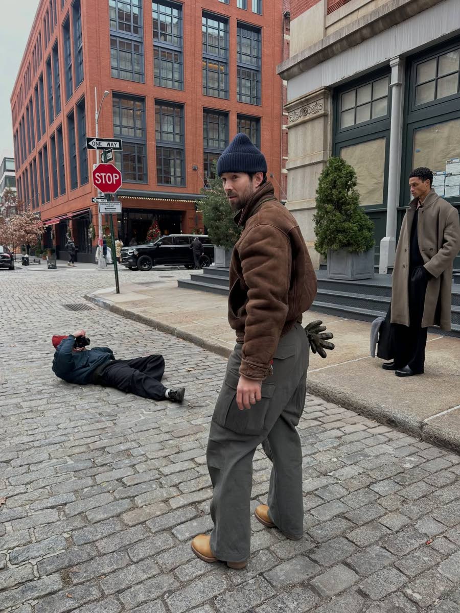 British menswear designer Daniel Simmons (foreground) on set for his Boxing Day collection campaign shoot as photographer Aiden Herron (lying on the ground) lenses SAINT International model Romaine Dixon.