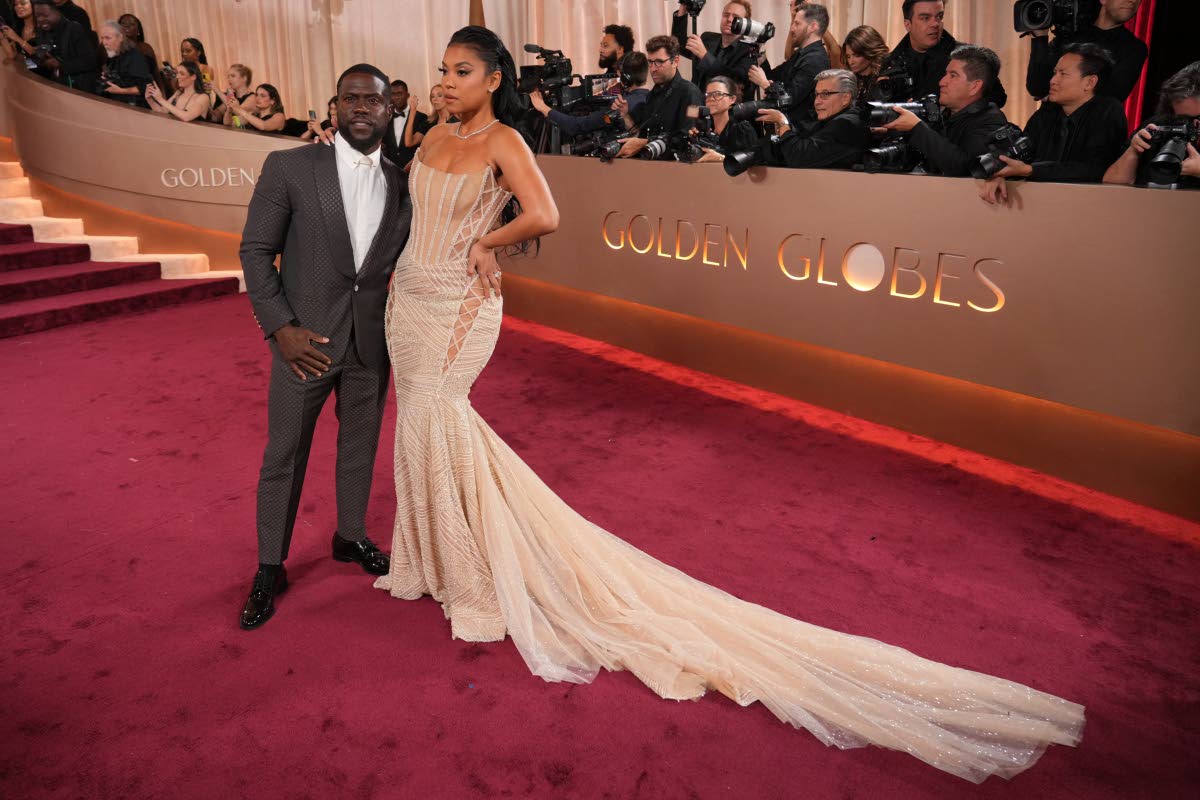 Kevin Hart and wife Eniko Hart pose for cameras on the Golden Globes red carpet, Kevin in Louis Vuitton and Eniko in Galia Lahav.