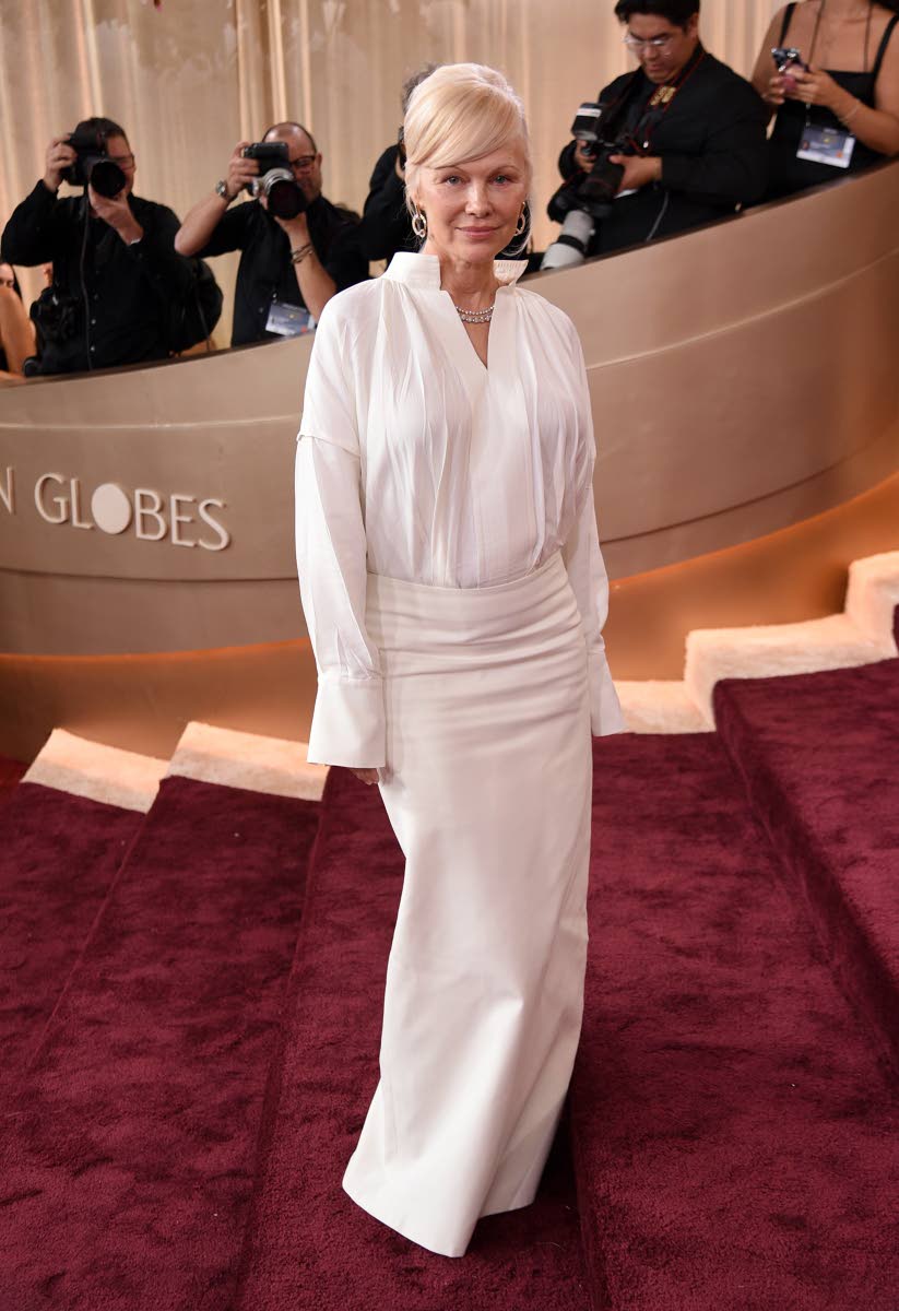 Pamela Anderson wears a custom Ferragamo piece designed by Maximilian Davis. 