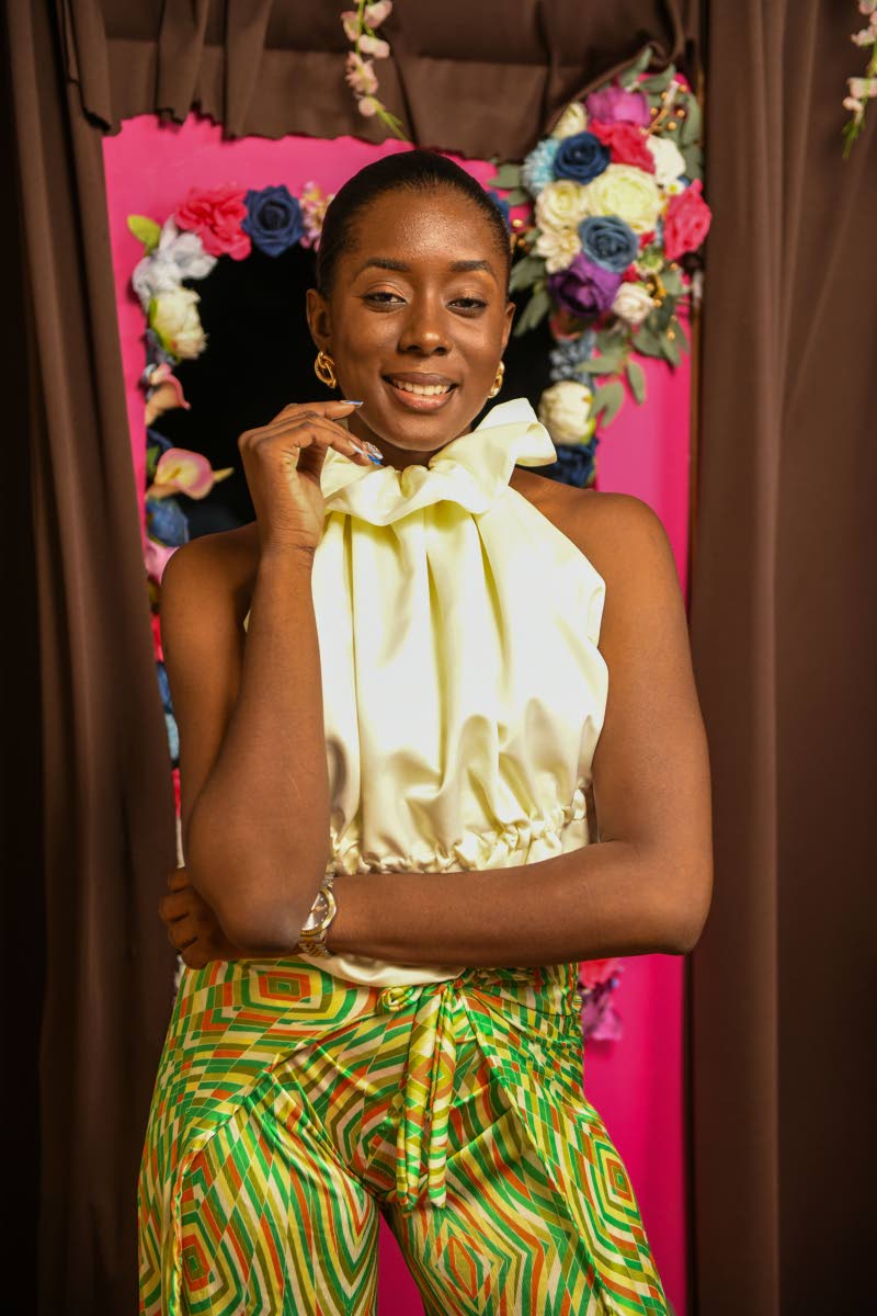 left: Rishema Daley wears an ivory puffed ruffled collar top and patterned green trousers.