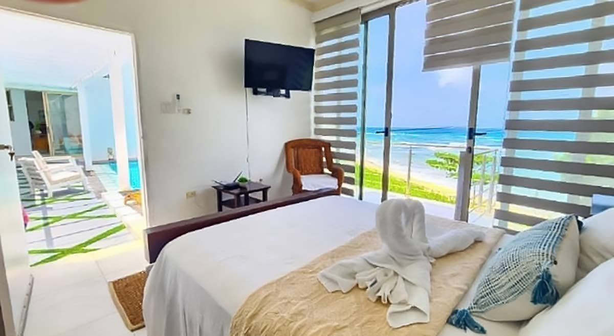 Bedrooms open to the middle floor pool deck and coastal views.