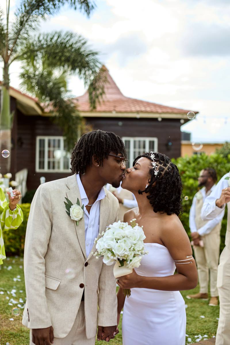 Right: The newly-weds seal the deal with a sweet kiss.